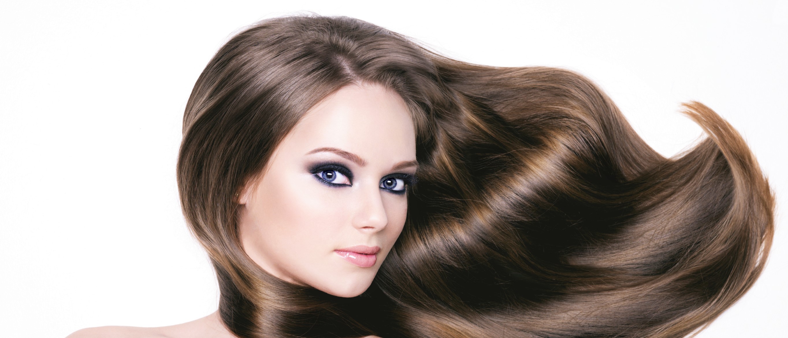 Portrait of a beautiful young woman with long hair and brighr black eye make-up- horizontal